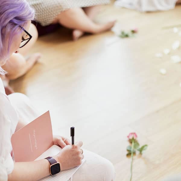 Writing in journal at wellness workshop